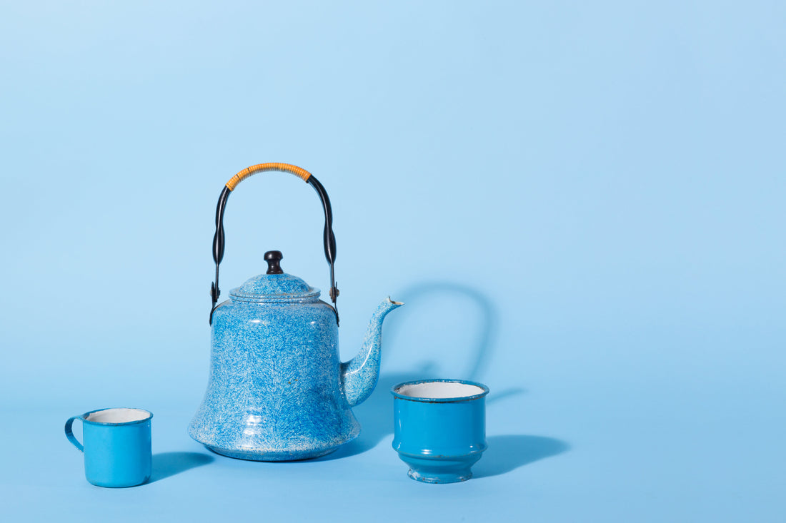 A dark brown Chinese teapot sitting on a wooden table